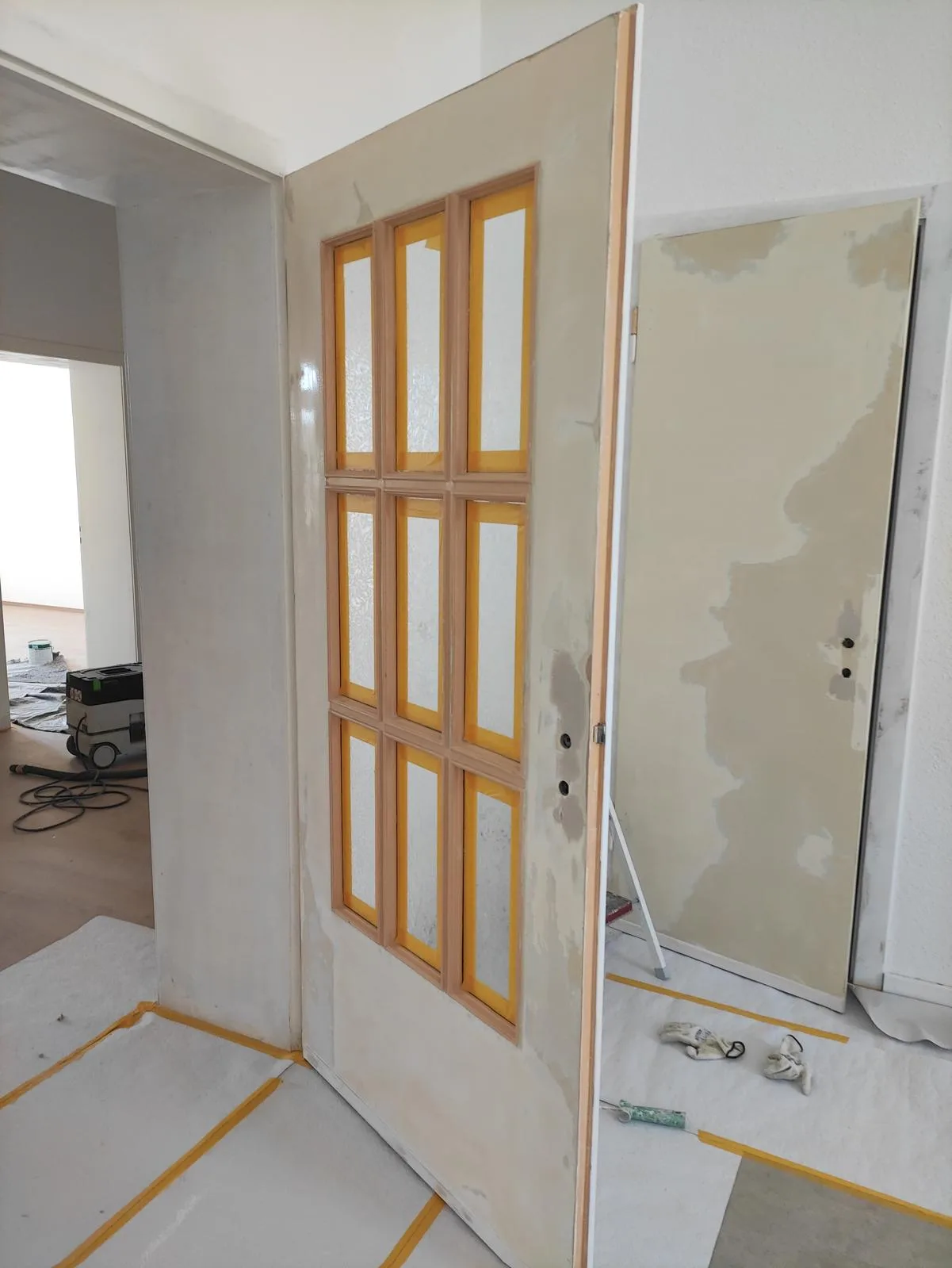 Installierte Innentür mit Glasfeldern in einem renovierten Raum